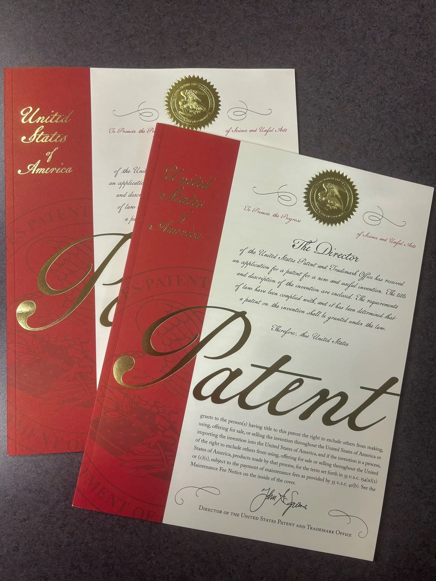 Two official United States Patent grant covers with gold USPTO seals.